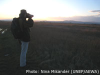 Sun sets on fields near the Evros river as Petteri Tolvanen from WWF Finland keeps a look out for geese / Photo: Nina Mikander (UNEP/AEWA)
