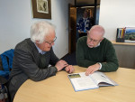 Peter Prokosch showing Jacques Trouvilliez the new edition of the book “The East Atlantic Flyway of Coastal Birds: 50 Years of Exciting Moments in Nature Conservation and Research”. (Photo: Florian Keil / UNEP/AEWA Secretariat)