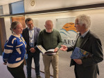 Jacques Trouvilliez and AEWA colleagues revieweing the new edition of the book “The East Atlantic Flyway of Coastal Birds: 50 Years of Exciting Moments in Nature Conservation and Research”. (Photo: Florian Keil / UNEP/AEWA Secretariat)